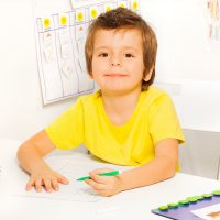 smiling young boy drawing