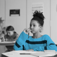 Portrait,Of,Teenage,African-american,Girl,Sitting,At,Desk,In,School