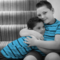 Brothers hugging at the stairs