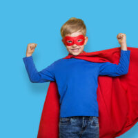 young boy in super hero costume