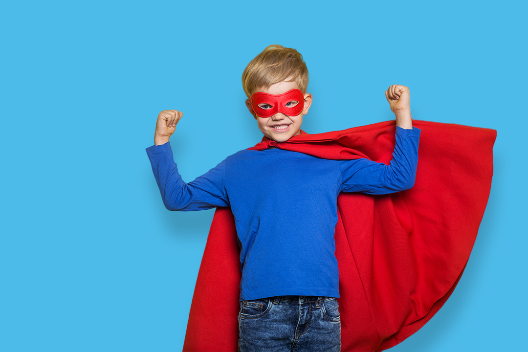 young boy in super hero costume