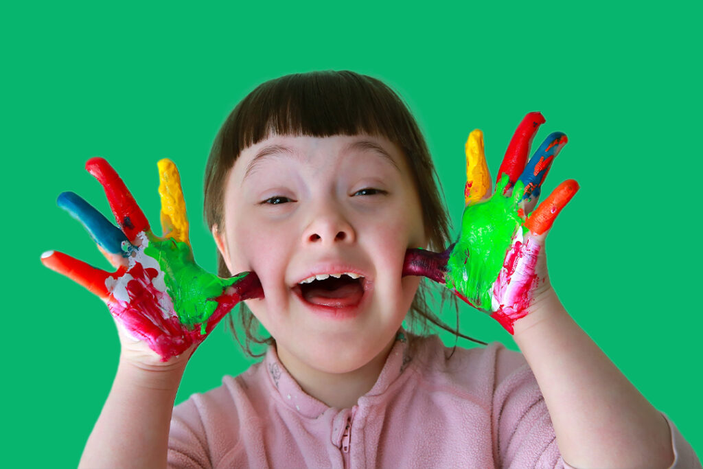 happy young girl painted hands up to face