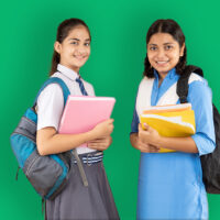 two young teen school girls with books and rucksacks