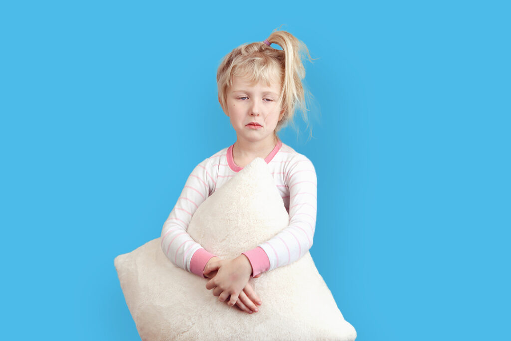 young girl with pillow standing cant sleep