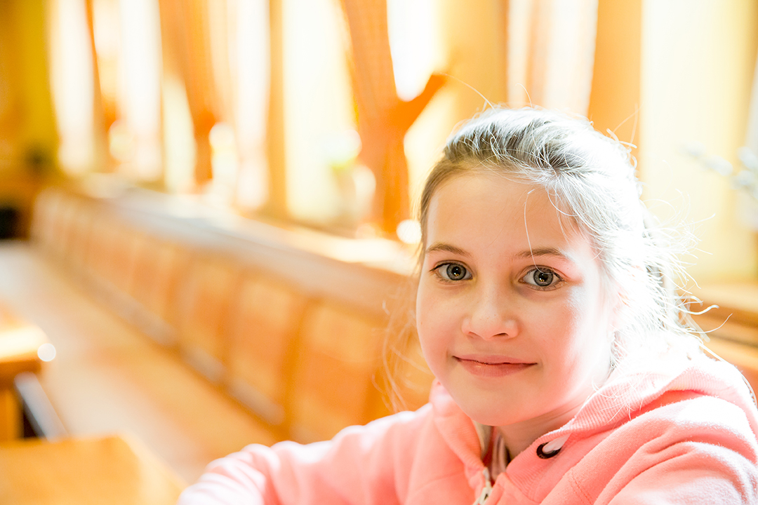 Tween girl in bright light hospital waiting room