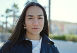Young,Beautiful,Hispanic,Woman,Standing,With,Serious,Expression,At,Street