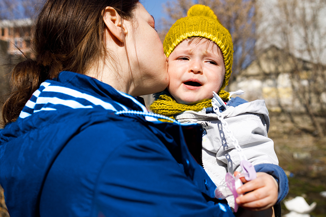 A mother soothing her crying child