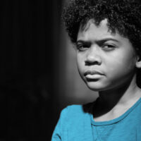 traumatised boy by wall