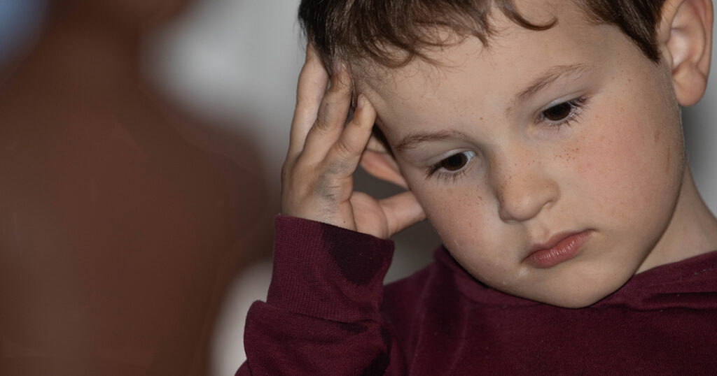 Child thinking close up dark silhouette shadow behind him mental health autism