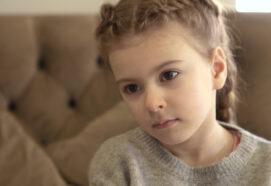 Portrait of little girl aged . Moody and confused girl. Mistreated child.