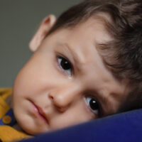 very sad boy. offended a child. close up portrait looking at the camera. feels lonely misses parents. freedom Ukraine