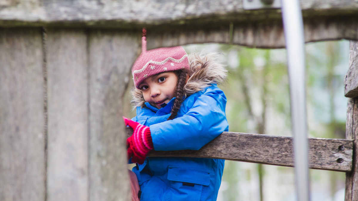 young girl playing in tree house in winter, sheltered by cold young girl playing in tree house in winter, sheltered by cold