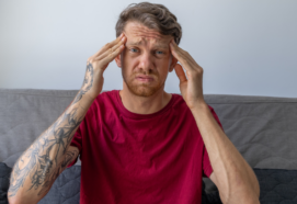 Man holding his head representing adhd training for professionals