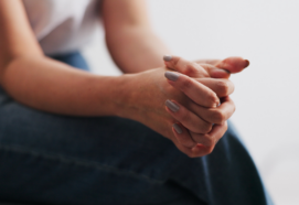 Woman with her hands together during trauma informed practice training